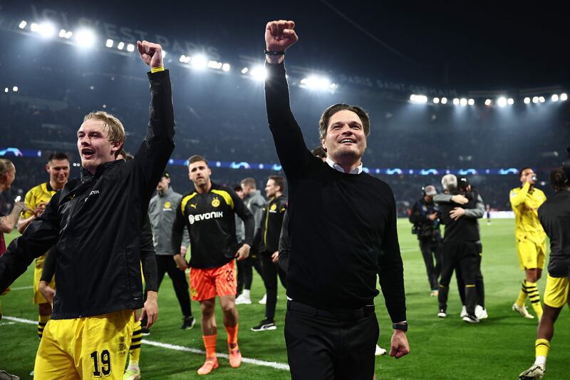 Dortmund manager Edin Terzic and midfielder Julian Brandt celebrate on front of the fans. AFP