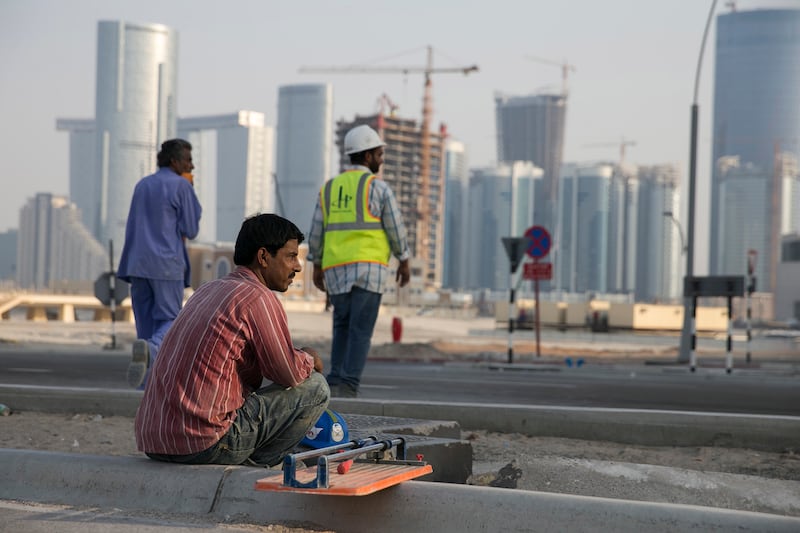 Abu Dhabi, UNITED ARAB EMIRATES, June 22, 2014:  
A construction worker rests at the end of nis shift, near new construction projects on Reem Island in Abu Dhabi as seen on Sunday, June 22, 2014.
(Silvia Razgova / The National)

Reporter: standalone 
Section: NA, BIZ
Usage: stock
