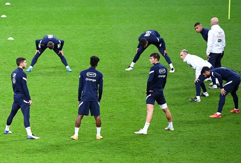 France players stretch and warm up during a training session at the Stade de France ahead of the Uefa Nations League match between France and Sweden. AFP