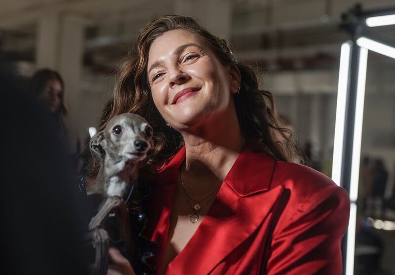 Drew Barrymore holds Tika the Iggy during an interview before viewing Christian Siriano's autumn/winter 2022 fashion collection at New York Fashion Week on Saturday. AP