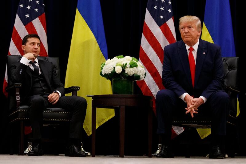 FILE - In this Sept. 25, 2019, file photo, President Donald Trump meets with Ukrainian President Volodymyr Zelenskiy at the InterContinental Barclay New York hotel during the United Nations General Assembly, in New York. Itâ€™s the story of a president who either had a â€œperfect phone callâ€ with Ukraine or abused his power and should be removed from office. What to watch as presidential impeachment arguments get underway in the Senate for only the third time in American history. (AP Photo/Evan Vucci, File)