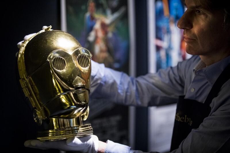 A promotional C-3PO helmet from 1983, estimated at £15,000-25,000,  goes on view at Sotheby's in London. Highlights from Sotheby's Star Wars Online sale are on view until 11 December, featuring posters, toys and props from the original trilogy. Getty Images