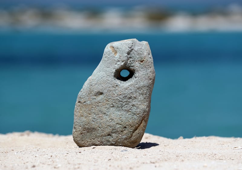 An ancient weight for pearl fishing was found at the site on Al Sinniyah Island