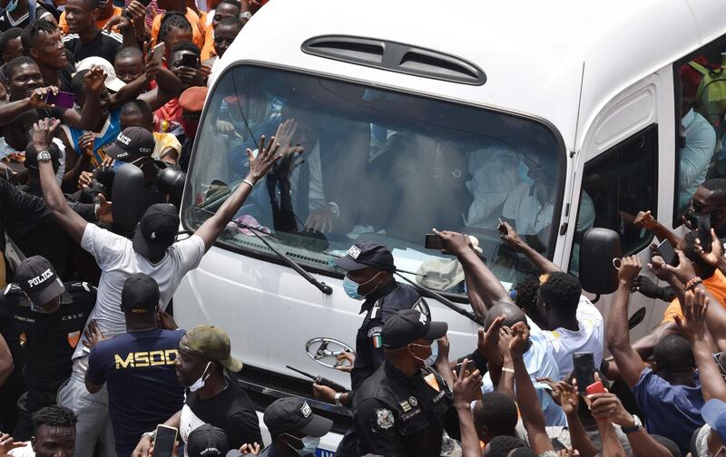 Didier Drogba's bus is surrounded by supporters. AFP