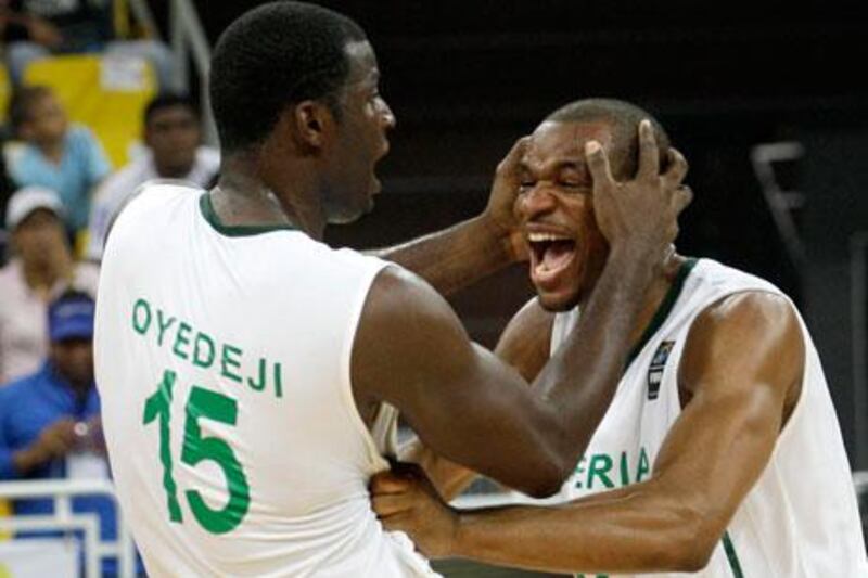 Olumide Oyedeji celebrates with Derrick Obasohan after Nigeria qualified for the London 2012 Olympic basketball competition