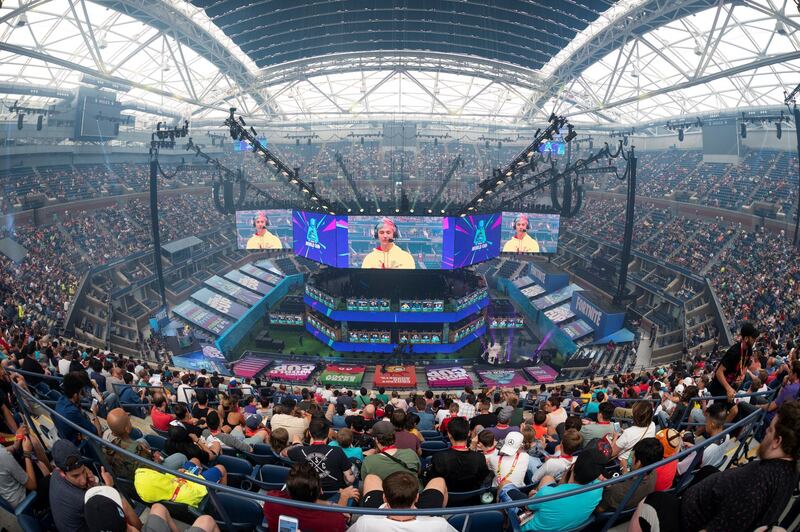 Richard Tyler Blevins (on screen), aka Ninja, speaks to the crowd at the start of the 2019 Fortnite World Cup Finals - Round Two on July 27, 2019, at Arthur Ashe Stadium, in New York City. (Photo by Johannes EISELE / AFP)