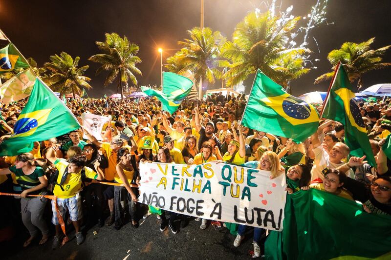 Supporters of Jair Bolsonaro celebrate in front of his house in Rio de Janeiro. Getty Images