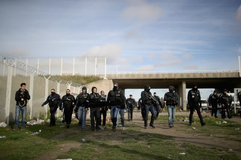 French police clearing the main entrance to the camp