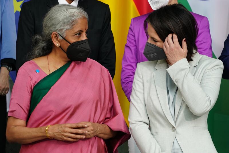 German Foreign Minister Annalena Baerbock, right, and Indian Finance Minister Nirmala Sitharaman talk during a family picture at the Chancellery in Berlin. EPA