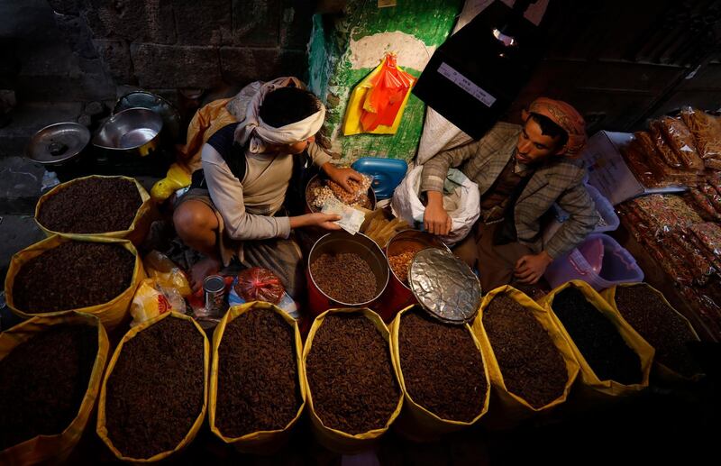 Yemeni vendors sell sun-dried raisins ahead of Eid Al Fitr at a market in Sanaa, Yemen.  EPA