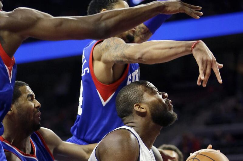 Detroit's Greg Monroe goes up and is fouled by Brandon Davies, left, of Philadelphia, during their NBA contest on Saturday night. Carlos Osorio / AP / December 6, 2014