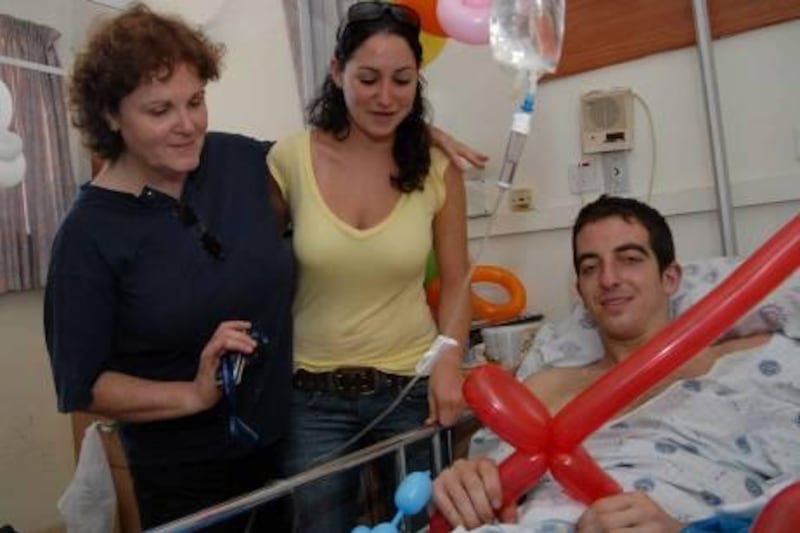 In this photo taken on Aug. 3, 2006, Israeli, U.S-born, Ilan Grapel, right, pauses for a photographer as he is hospitalized after he was injured during the Israel Lebanon war at the Rambam hospital in the northern Israeli city of Haifa. A statement from the Israeli prime minister's office says Egypt has agreed to release a dual US-Israeli citizen held since June on spy suspicions. The statement from Prime Minister Benjamin Netanyahu's office Monday Oct. 24, 2011 said Israel will release 25 Egyptian prisoners in exchange. There was no immediate comment from Egypt. Ilan Grapel was arrested in Cairo on June 12 and has been held without charge since.(AP Photo/Ancho Gosh) ISRAEL OUT   *** Local Caption ***  Mideast Israel Palestinians Egypt.JPEG-07678.jpg