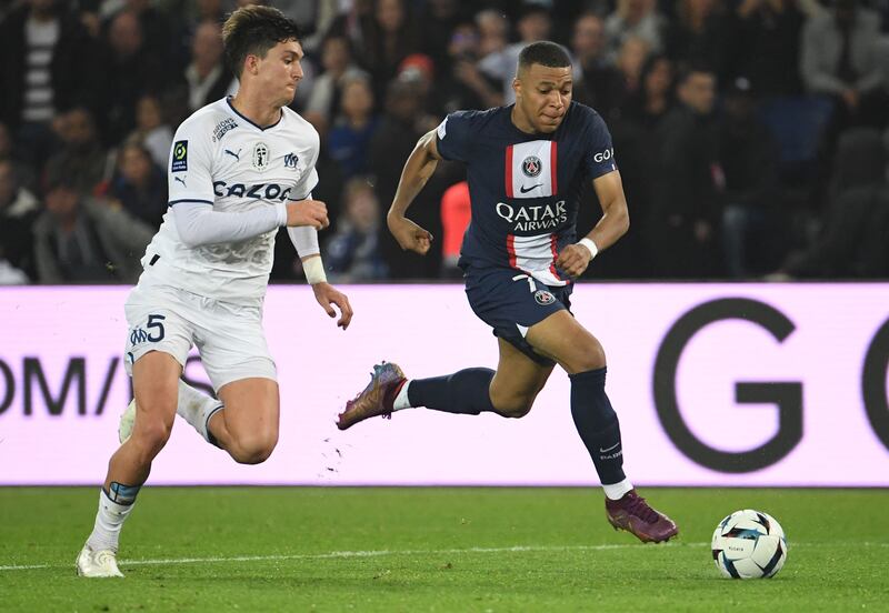 Marseille's Argentine defender Leonardo Balerdi fights for the ball with Paris Saint-Germain's French forward Kylian Mbappe. AFP