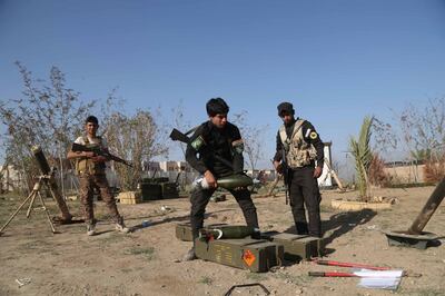 FILE - In this March 15, 2015 file photo, young Shiite volunteer militia members prepare to attack Islamic State fighters in Tikrit, north of Baghdad, Iraq. From Lebanon and Syria to Iraq, Yemen, and the Gaza Strip, Iran has significantly expanded its footprint over the past decade, finding and developing powerful allies in conflict-ravaged countries across the Middle East. Iran has trained, financed, and equipped Shiite militias in Iraq that battled U.S. forces in the years after the 2003 invasion and remobilized to battle the Islamic State group a decade later. (AP Photo/Khalid Mohammed, File)