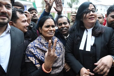 Asha Devi, the mother of 23-year-old Jyoti Singh who was killed in a gang rape victim in 2012, shows a victory sign at Patiala House Court in New Delhi. EPA