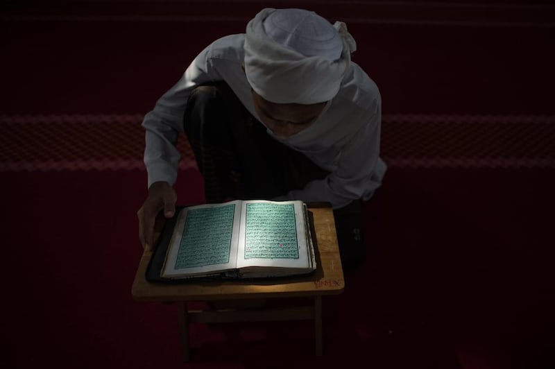 A Malaysian student reads the Quran at a school in Hulu Langat, near Kuala Lumpur on June 30, 2014. Mohd Rasfan/AFP Photo