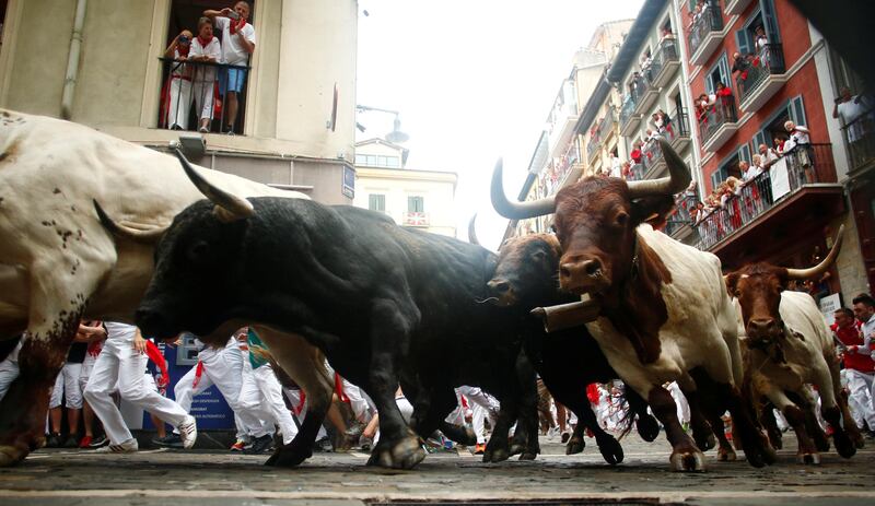 Hundreds of people test their bravery and speed to dash through the streets with six fighting bulls without getting gored. Vincent West / Reuters
