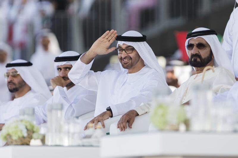 Sheikh Mohammed bin Zayed, Crown Prince of Abu Dhabi and Deputy Supreme Commander of the Armed Forces, waves to tribesmen participating in the Union March during the Sheikh Zayed Heritage Festival. He is seen here with Sheikh Mohammed bin Rashid Al Maktoum, Vice President and Ruler of Dubai, Sheikh Hamdan bin Mohammed, Crown Prince of Dubai and Sheikh Hamdan bin Zayed, Ruler’s Representative in the Western Region of Abu Dhabi. Philip Cheung / Crown Prince Court - Abu Dhabi