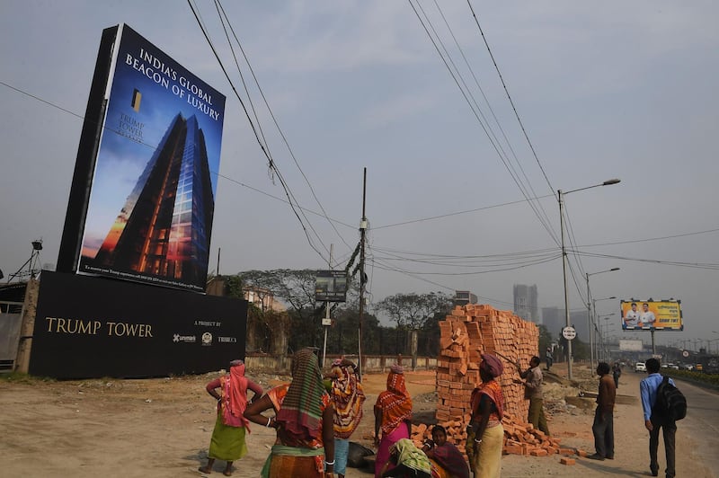 Indian labourers work on the road leading to the under-construction Trump Tower in Kolkata on February 20, 2018. Dibyangshu Sarkar / AFP