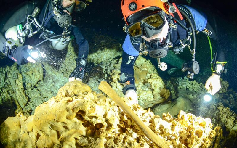 Divers from the Great Mayan Aquifer project exploring the Sac Actun underwater cave system where Mayan and Pleistocene bones and cultural artifacts have been found submerged, near Tulum. Jan Arild Aaserud/Great Mayan Aquifer Project-INAH via AP
