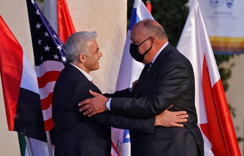 Mr Lapid, left, greets Egyptian Foreign Minister Sameh Shoukry on his arrival. AFP