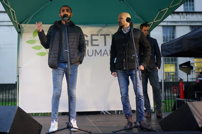 Hamze Awawd, left, a Palestinian peace activist who lives in Ramallah in the occupied West Bank, and Magen Inon, whose parents were killed by Hamas on October 7, speak at the anti-hate vigil. PA
