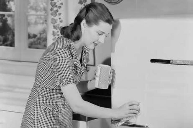 ENGLAND - AUGUST 07:  A photograph of a woman in a kitchen cleaning the door of a 'Hotpoint' fridge, taken by Photographic Advertising Limited in about 1955. In Britain at this time fridges were luxury items. The company heavily promoted their studio kitchen and its authenticity appealed to advertisers. Photographic Advertising Limited, founded in 1926, created multi-purpose stock images with the potential for selling a range of products. Whilst enjoying its greatest success during the 1930s, it continued in business until 1977. Their trademark, the staged studio photograph resembling a film still, was its selling point and, later, its downfall. Sophisticated, adaptable and generic, this kind of image gradually fell out of favour as clients increasingly demanded targeted advertising campaigns with specific photographs.  (Photo by SSPL/Getty Images)