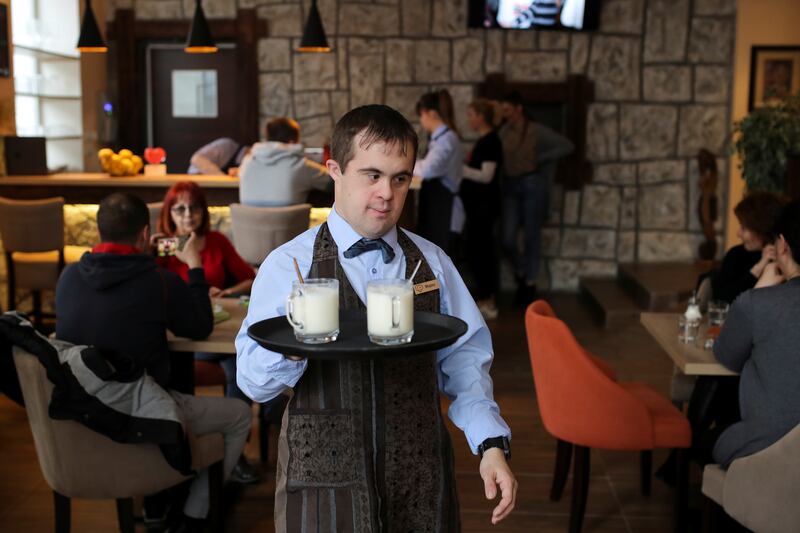Marko serves drinks in Zvuci Srca cafe in Belgrade, Serbia. Reuters