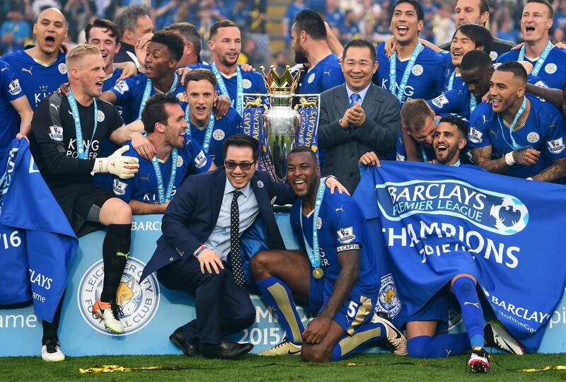 LEICESTER, ENGLAND - MAY 07:  Captain Wes Morgan, owner Vichai Srivaddhanaprabha, his son Aiyawatt Srivaddhanaprabha and players celebrate the season champions with the Premier League Trophy after the Barclays Premier League match between Leicester City and Everton at The King Power Stadium on May 7, 2016 in Leicester, United Kingdom.  (Photo by Shaun Botterill/Getty Images)