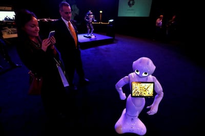 FILE PHOTO: A visitor takes pictures of a robot during an exhibition on 'Neom', a new business and industrial city, in Riyadh, Saudi Arabia, October 25, 2017. REUTERS/Faisal Al Nasser/File Photo