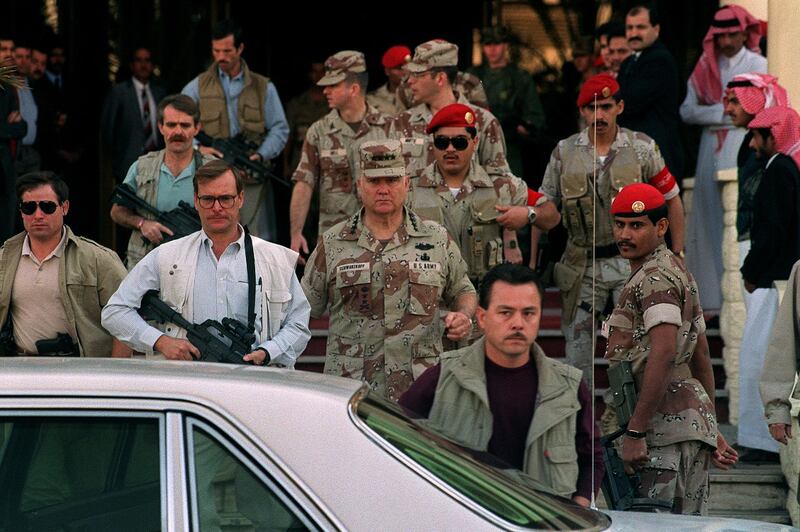 Gulf War commander, US four star general Norman Schwarzkopf (C), who commanded the international coalition which ousted Iraqi forces from Kuwait during Operation Desert Storm, leaves 10 February 1991 in Riyadh the Hotel Hayatt under the watchful eyes of his bodyguards. (Photo by MICHEL GANGNE / AFP)