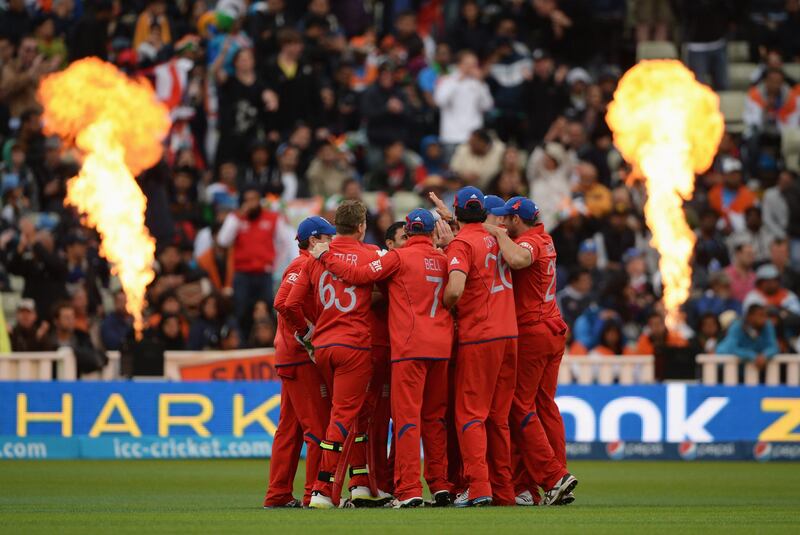 BIRMINGHAM, ENGLAND - JUNE 23: England players celebrate the wicket of Mahendra Singh Dhoni of India as flame throwers are set off during the ICC Champions Trophy Final between England and India at Edgbaston on June 23, 2013 in Birmingham, England.  (Photo by Gareth Copley/Getty Images) *** Local Caption ***  171208245.jpg