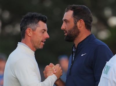 Scottie Scheffler shakes hands with Rory McIlroy on the 18th hole after completing their second round. Reuters