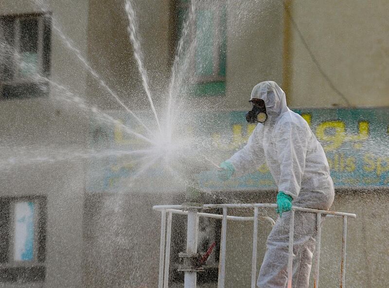 A municipality worker sprays disinfectant at the Kuwait salmiya market. EPA