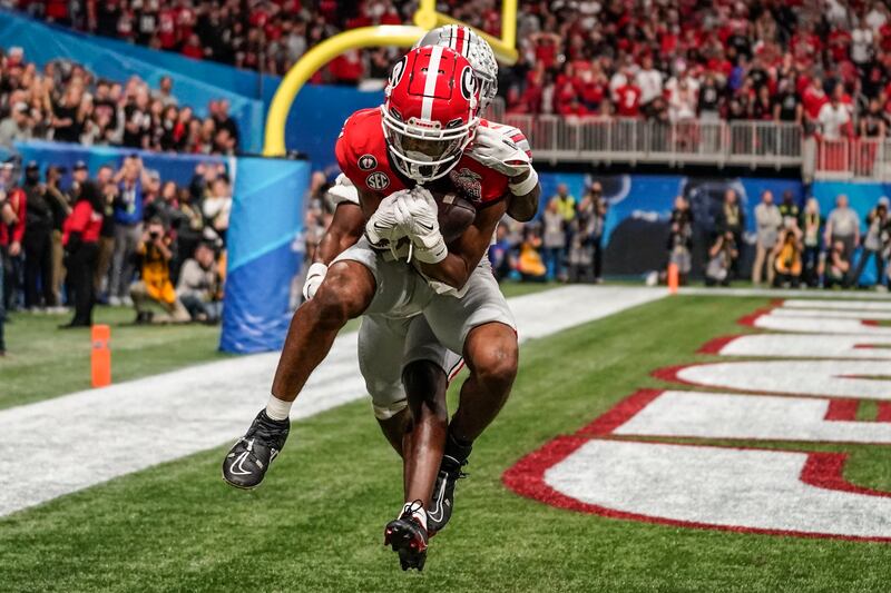 Georgia's Adonai Mitchell makes a touchdown catch against Ohio State's Denzel Burke during the Peach Bowl college football semi-final game in Atlanta. AP Photo