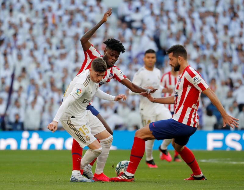 Atletico Madrid's Felipe vies for the ball with Real Madrid's Federico Valverde at the Santiago Bernabeu. Reuters