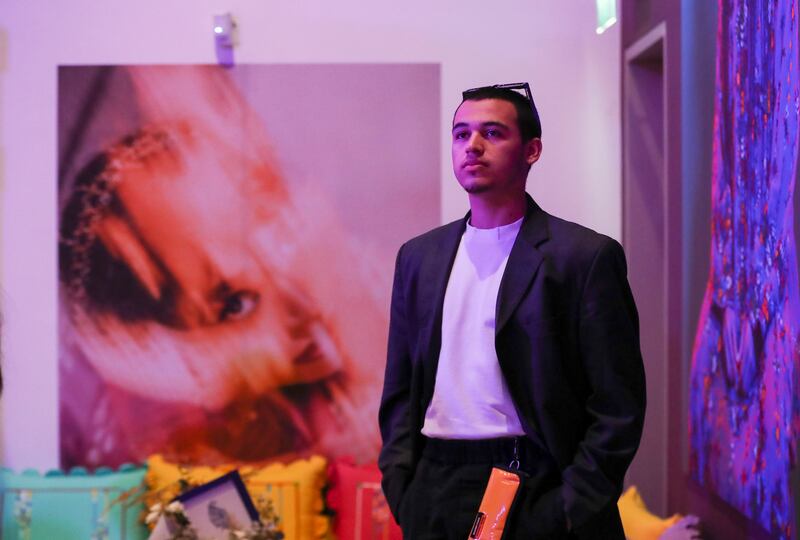 Half-Emirati, half-Welsh photographer Zayed Alhaddar stands next to his work at the Khaleejiness exhibition at Manarat Al Saadiyat Photography Studio. Khushnum Bhandari / The National