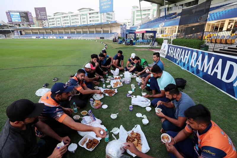 Players breaking their fast before the start of Sharjah Ramadan Cup final at Sharjah International Cricket Stadium in Sharjah on April 7,2021. Pawan Singh / The National. Story by Paul