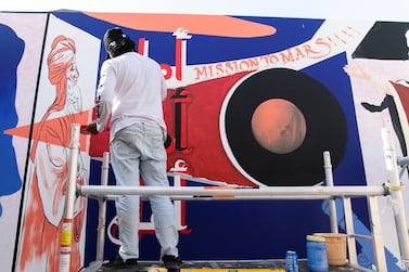 DUBAI, UNITED ARAB EMIRATES. 25 JULY 2020. Artists Amna Basheer and Reem Al Mazrouei work on their commission for Dubai Culture. They are painting a “Hope mural” to celebrate the UAE Mars mission in Dubai’s Al Fahidi district. (Photo: Reem Mohammed/The National) Reporter: Section: