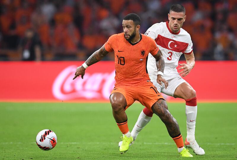 Netherlands forward Memphis Depay fights for the ball with Turkey defender Merih Demiral. AFP