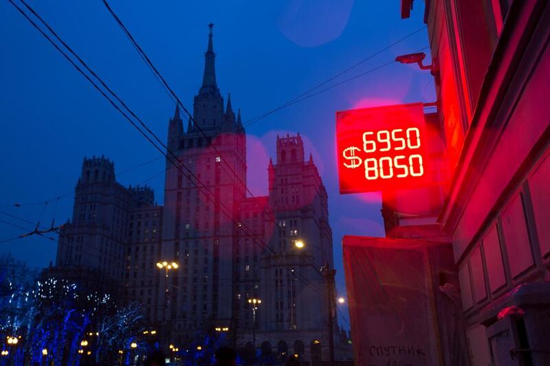 A neon sign displays the latest Russian ruble euro dollar exchange rate outside a currency exchange bureau in Moscow, Russia, on Tuesday, December 16, 2014. The rouble sank to a record, deepening Russia's currency crisis, as people scrambled to convert their money into dollars after a surprise interest-rate increase failed to shore up investor confidence. Andrey Rudakov / Bloomberg