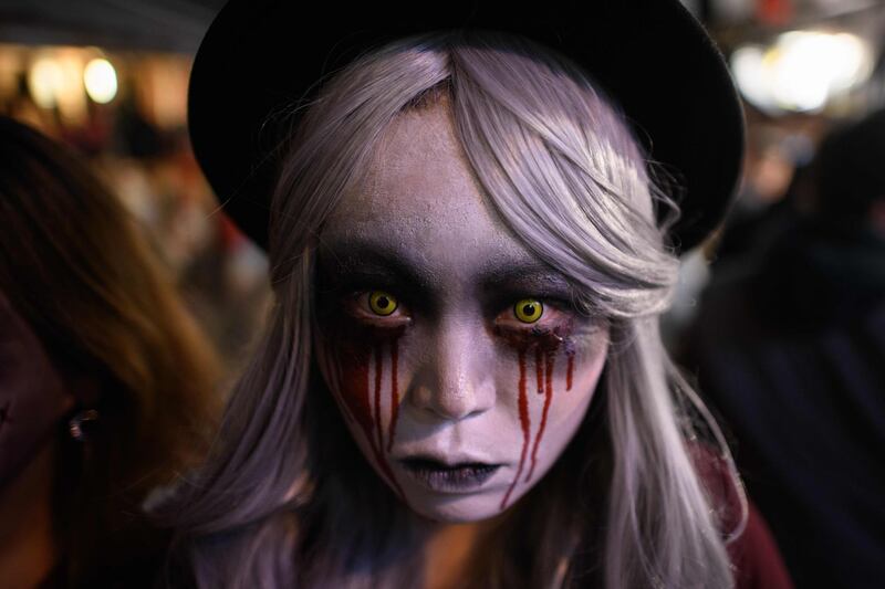 A reveller wearing Halloween make-up poses for a photo in the popular nightlife district of Itaewon in Seoul. AFP