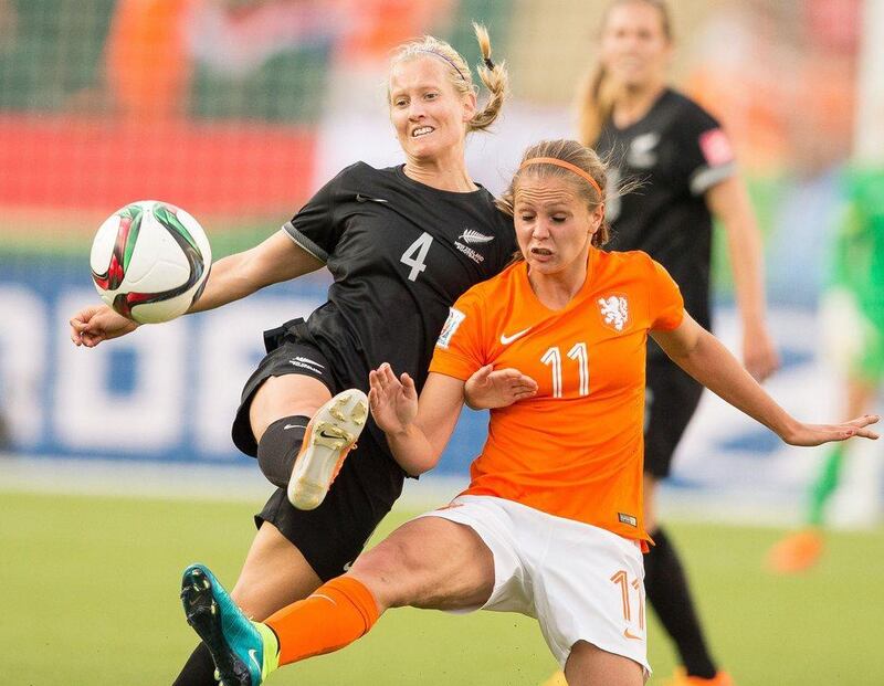 New Zealand's Katie Duncan, left, and the Netherlands' Lieke Martens vie for the ball during their Group A football match at Commonwealth Stadium on the opening day of the Fifa Women's World Cup in Edmonton, Canada on June 6, 2015. AFP PHOTO/ GEOFF ROBINS