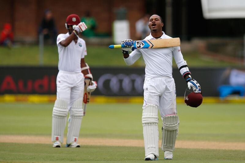 West Indies batsman Marlon Samuels, right, celebrates his century during the 4th day of the second Test against South Africa in Port Elizabeth on December 29, 2014.  Marco Longarj/AFP Photo 

