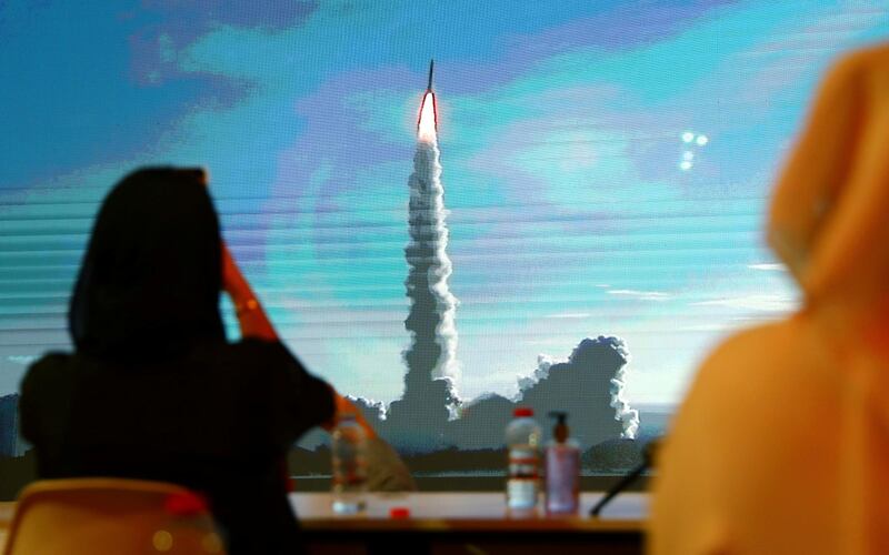 People watch a big screen displaying the launch of the Hope Probe from Tanegashima Island in Japan, at the Mohammed bin Rashid Space Centre in Dubai, United Arab Emirates July 20, 2020. REUTERS/Ahmed Jadallah