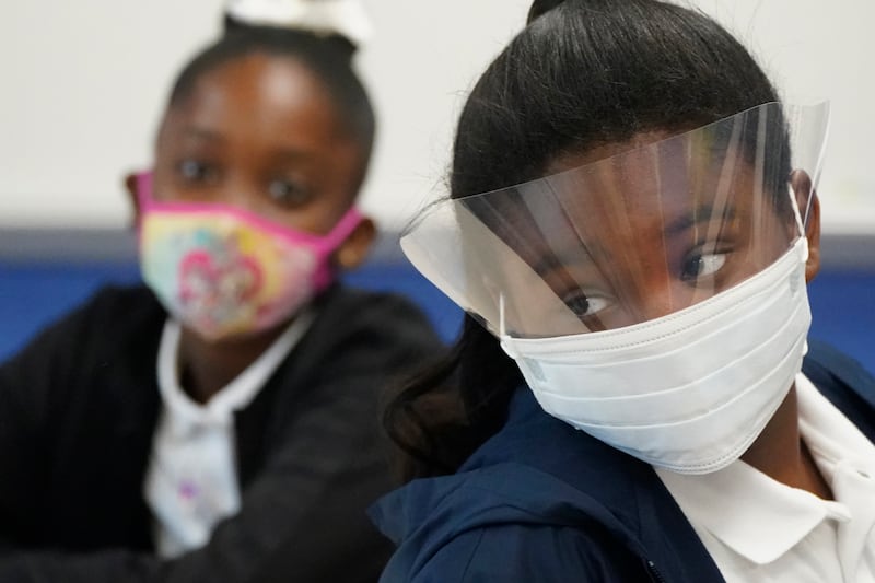 Fifth-grade students wearing masks to help prevent the spread of Covid-19, listen during class, on August 10, 2021, during the first day of school at Washington Elementary School in Riviera Beach, Florida. AP