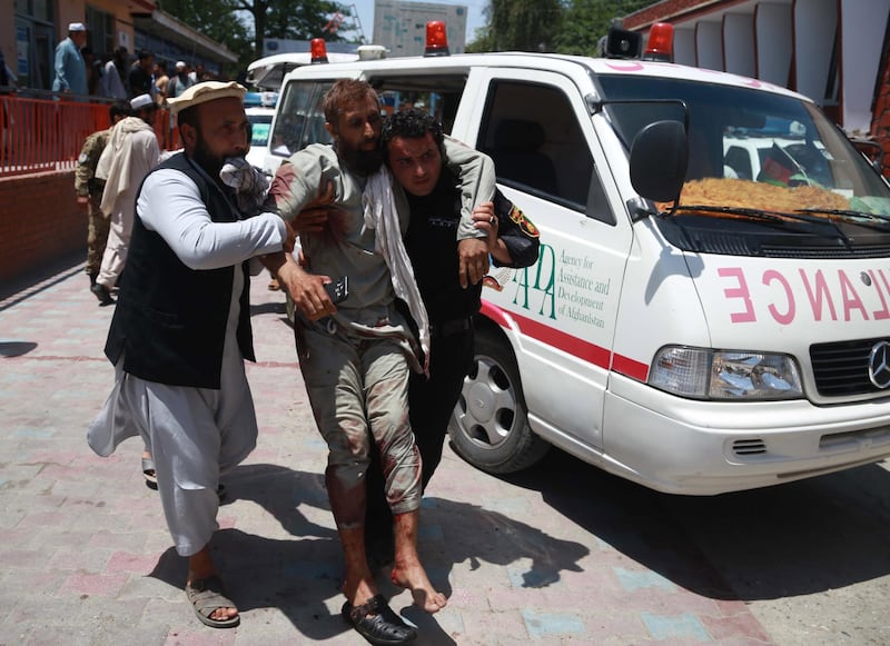 People shift injured victims of a suicide bomb attack to a hospital in Jalalabad, Afghanistan.  EPA