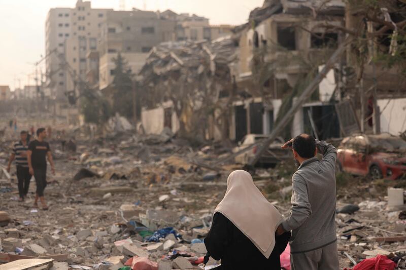 Palestinians inspect the destruction from Israeli air strikes in Gaza city's Al Rimal district on Tuesday. AFP
