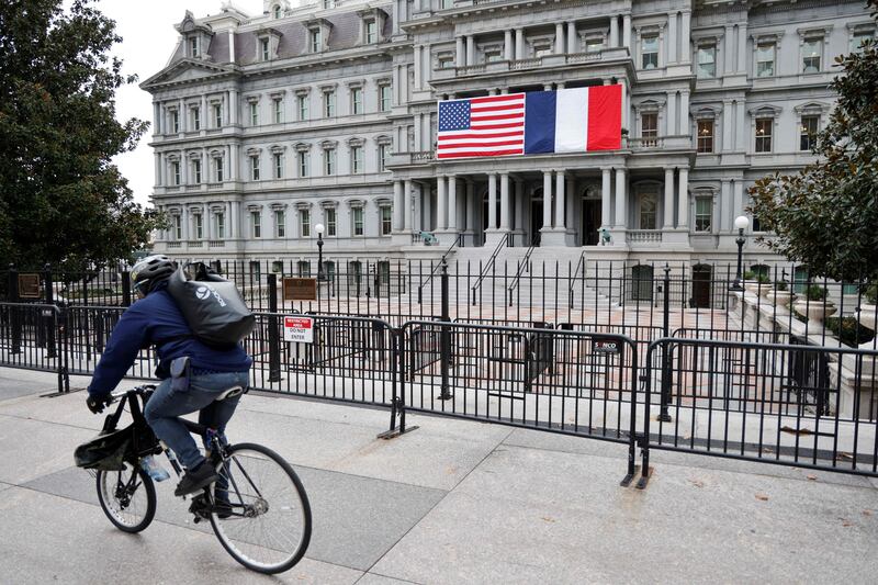 The French and US flags adorn the Eisenhower Executive Office Building next to the White House. AFP