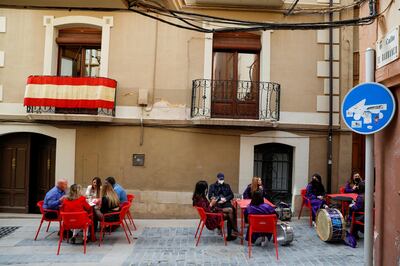 FILE PHOTO: People at a restaurant terrace at the end of Good Friday's "Rompida de la Hora" (Breaking of the hour) in Calanda, Spain, April 2, 2021. REUTERS/Susana Vera/File Photo